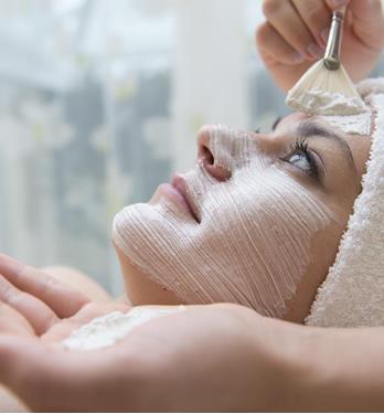 A woman is getting a facial treatment