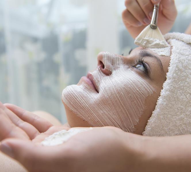 A woman is getting a facial treatment